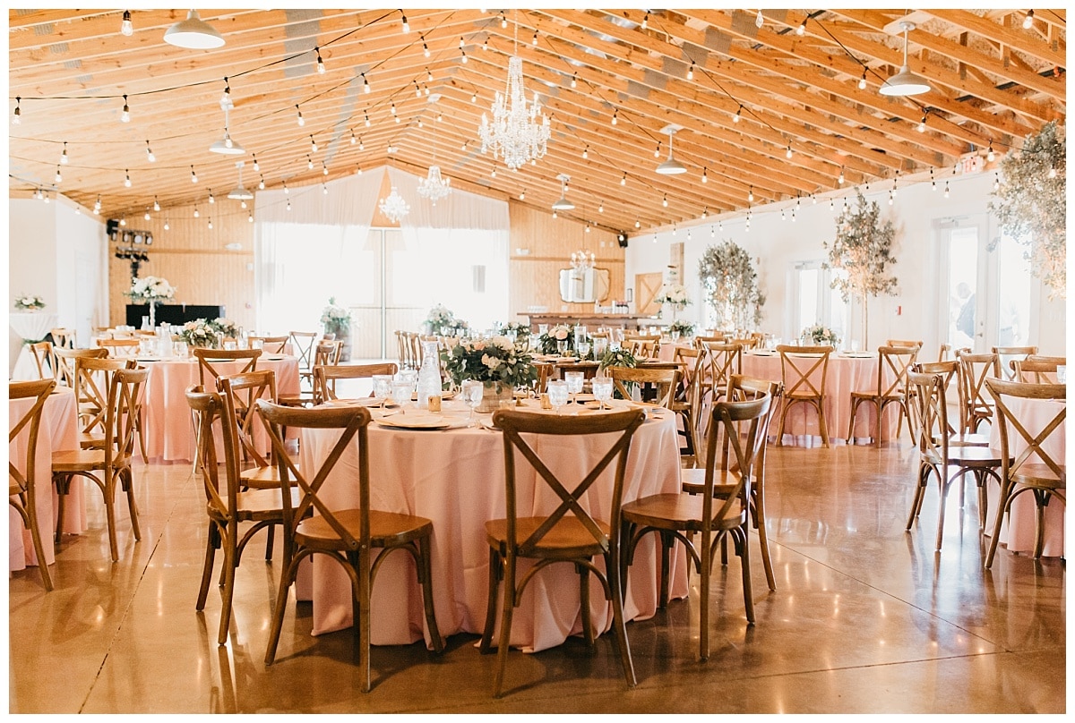 cafe style string lights and blush linens at a rustic reception at the boathouse at up the creek farms