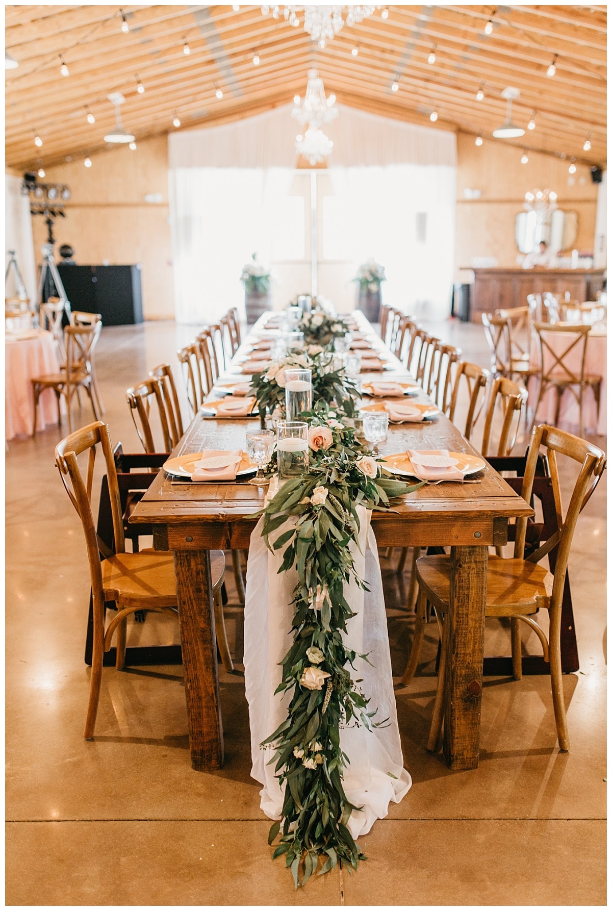 greenery table runners and light airy linens filled rustic farm tables