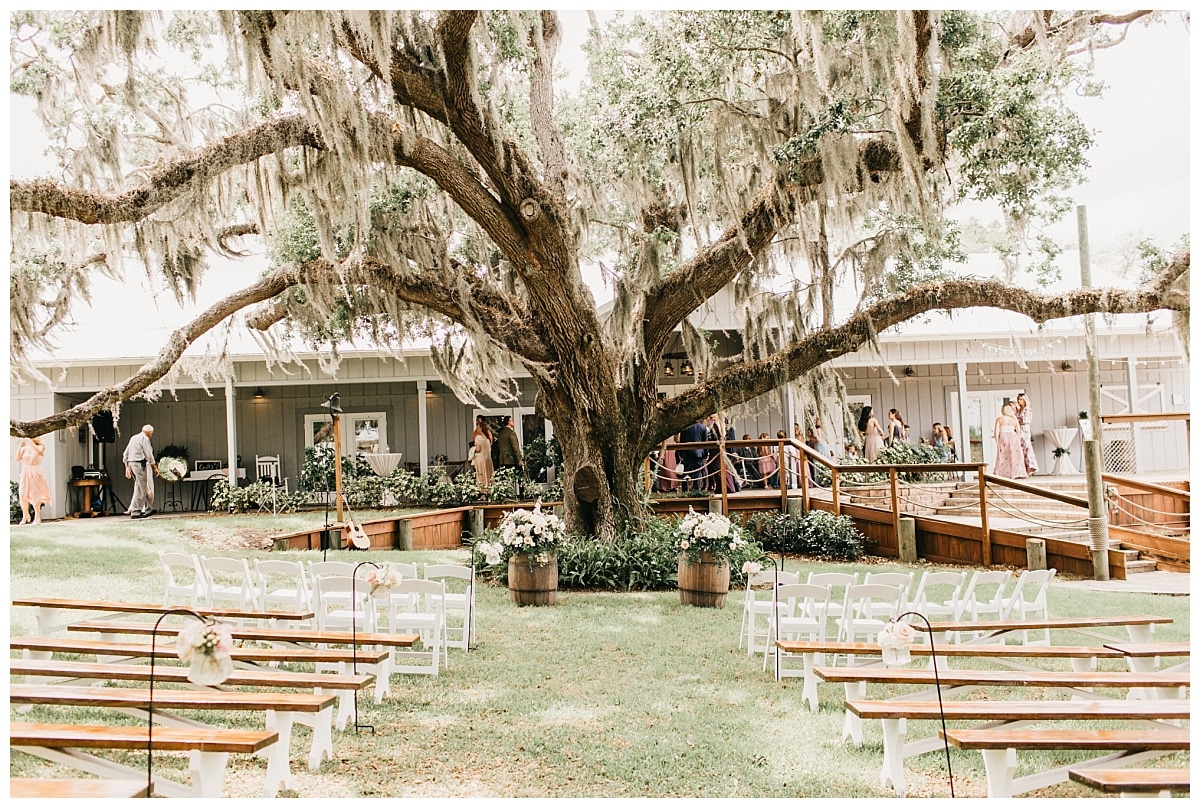 Beautiful outdoor wedding ceremony beneath the mossy oak trees of up the creek farms