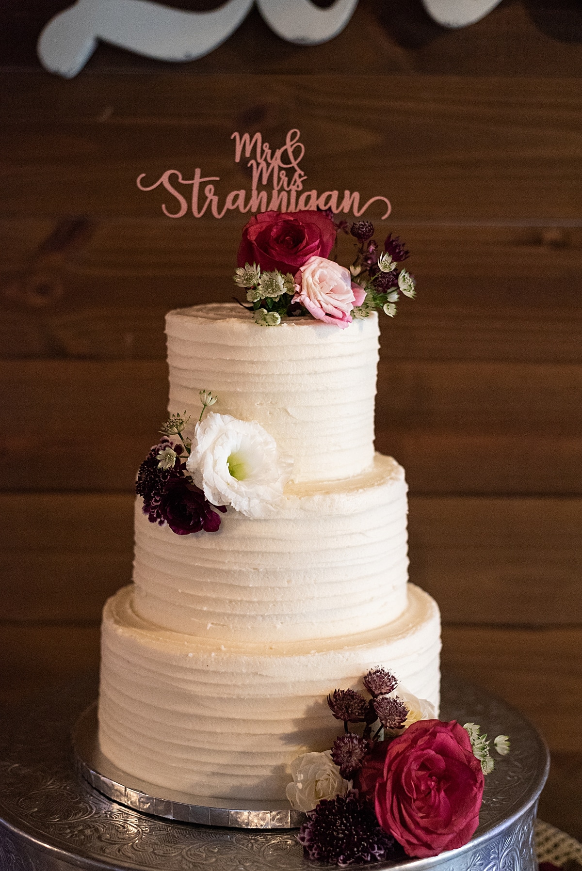 wooden pallet backdrop and classic 3 tiered wedding cake on crystal and crates vintage silver cake stand