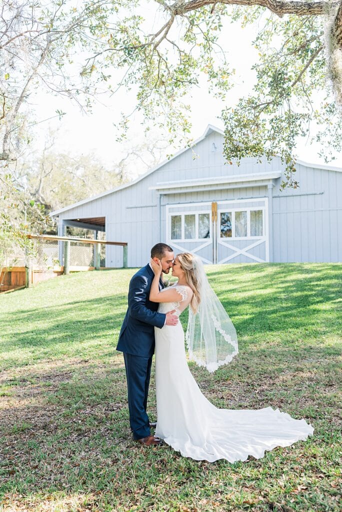 brevard county couple kissing in front of up the creek farms boathouse