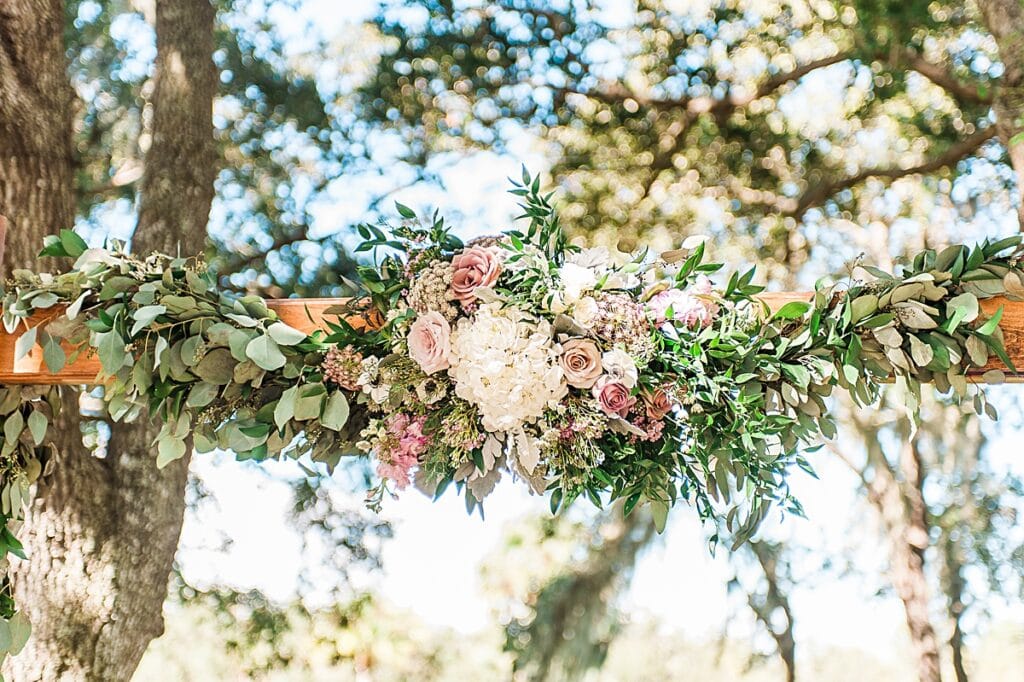 rustic natural arbor florals featuring seeded eucalyptus greenery and pale pink flowers