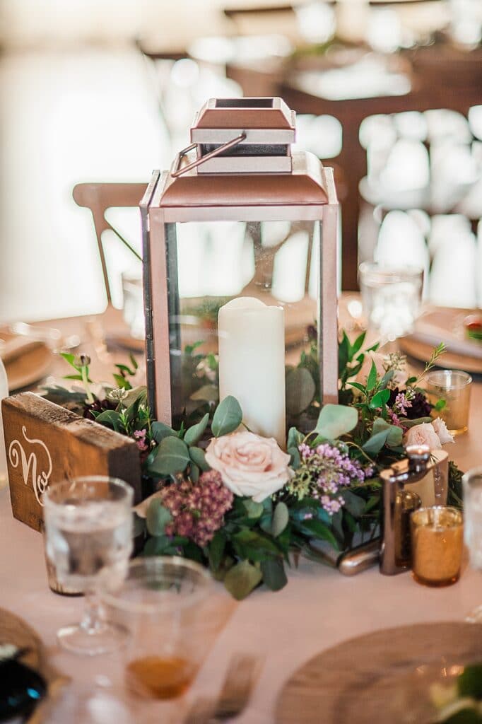 Rustic natural reception centerpieces with wooden table numbers and textured florals