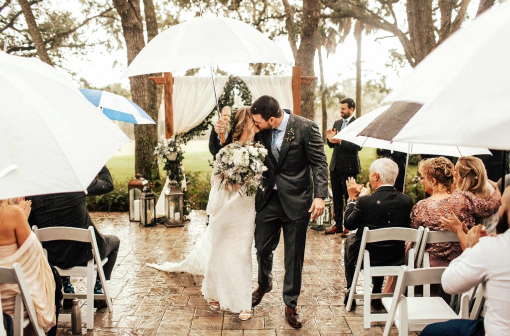 picture perfect rainy outdoor wedding ceremony at up the creek farms in brevard county 