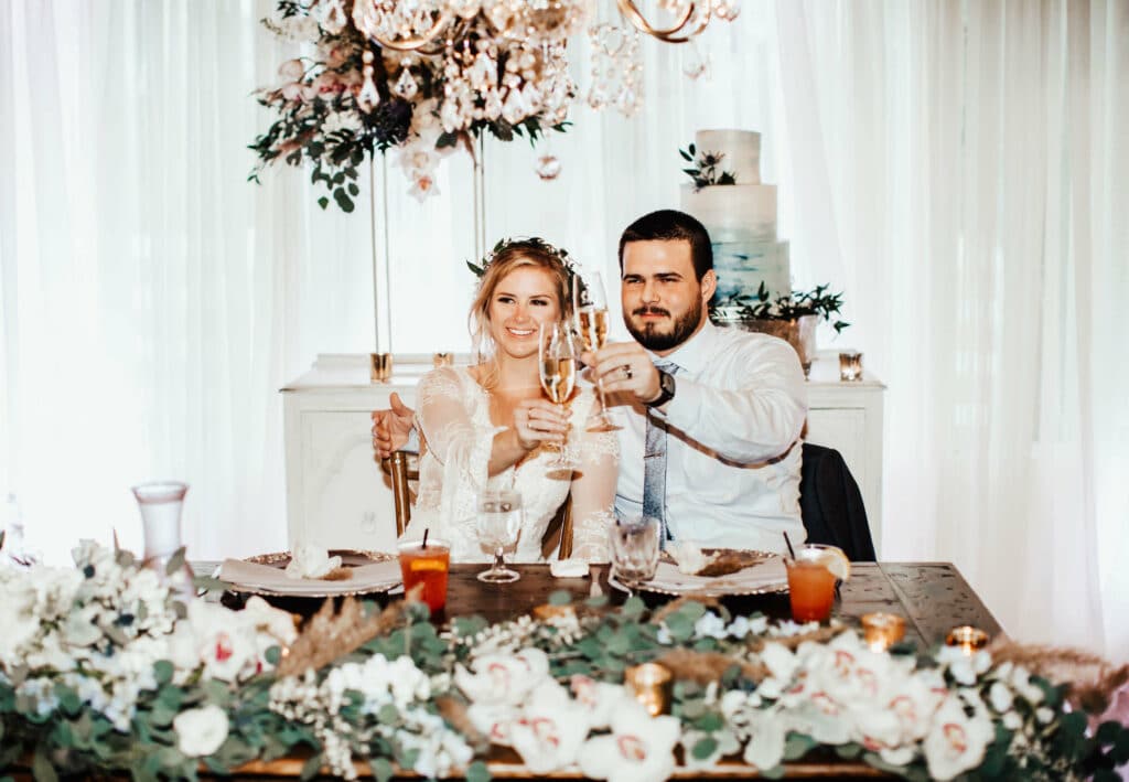brevard county sweetheart table with bohemian couple and whimsical flowers