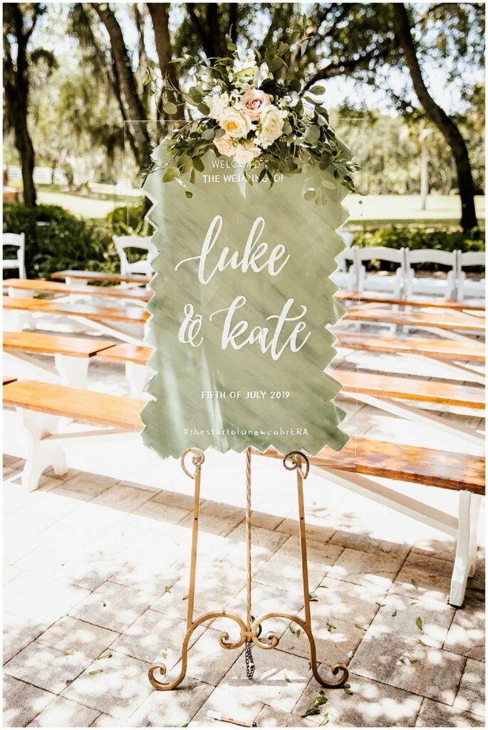Custom hand drawn olive green welcome sign for outdoor wedding ceremony