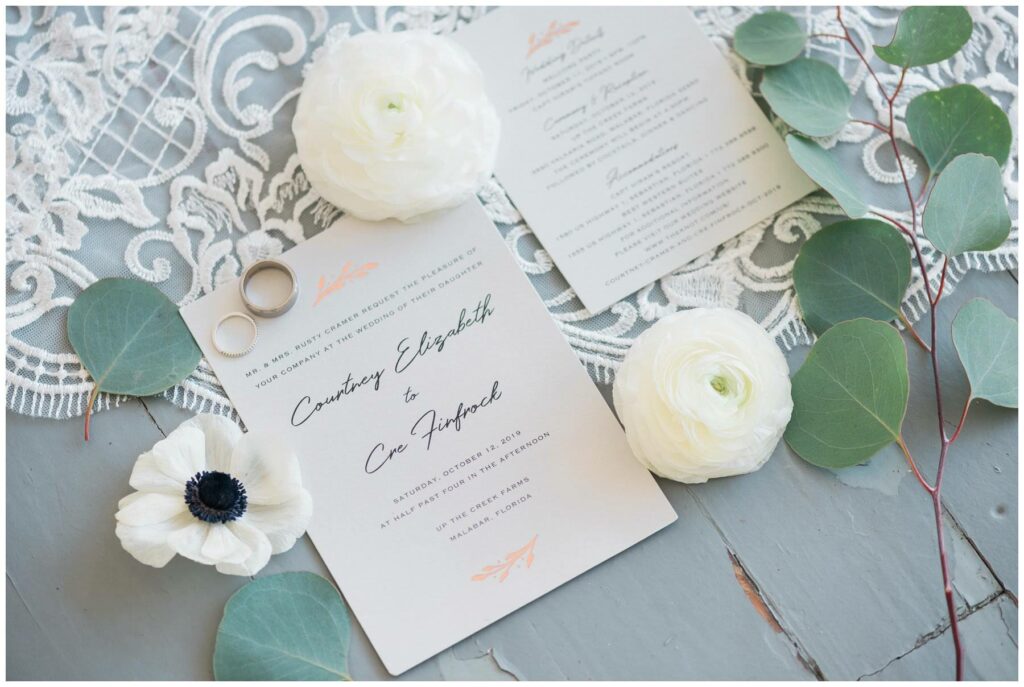 unique and modern wedding invitations featuring neon orange floral accents