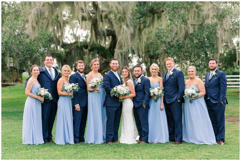 Periwinkle blue strapless bridesmaid dresses and navy blue groomsmen suits