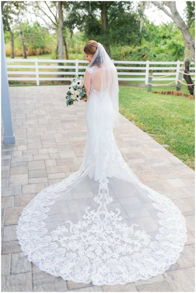Beautiful lace wedding dress with sheer classic lace train from Merlili Bridal Boutique in Miami