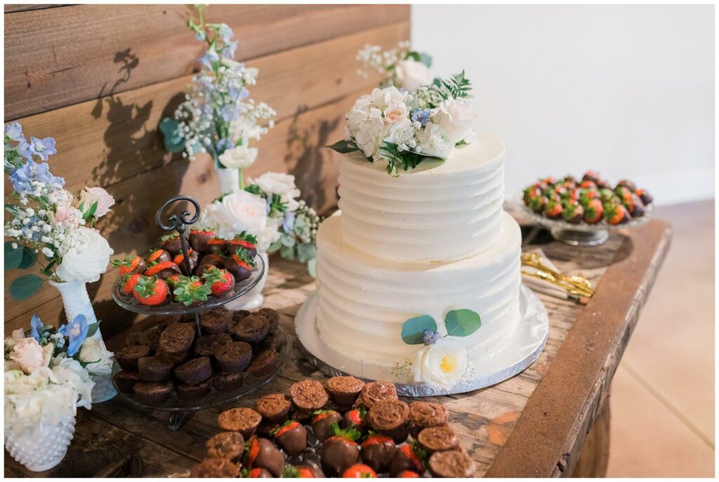 Wedding reception dessert display with brownie bites and chocolate covered strawberries