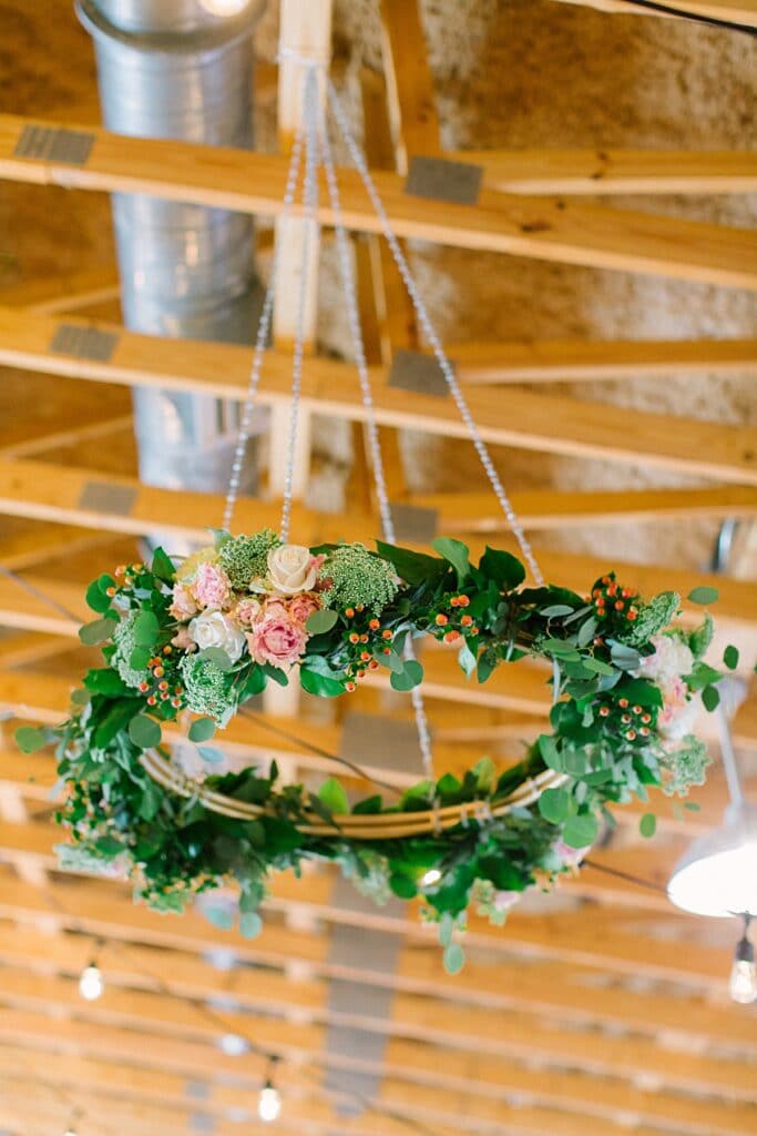 rustic greenery covered chandelier ceiling installation for wedding reception design 