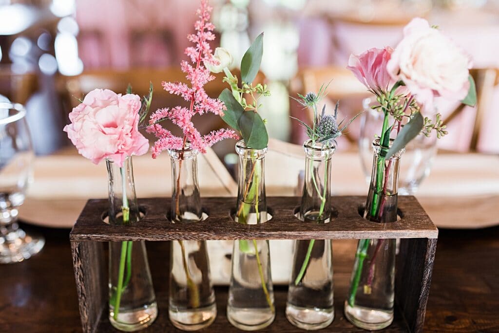 budget friendly wedding flower tips include using single bud jars and vases