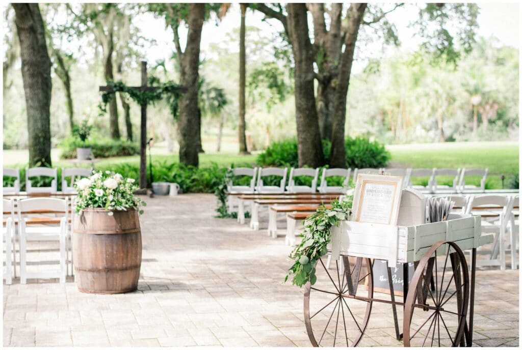 custom wooden ceremony cross complete with vintage whiskey barrel decor and antique white flower cart card display table