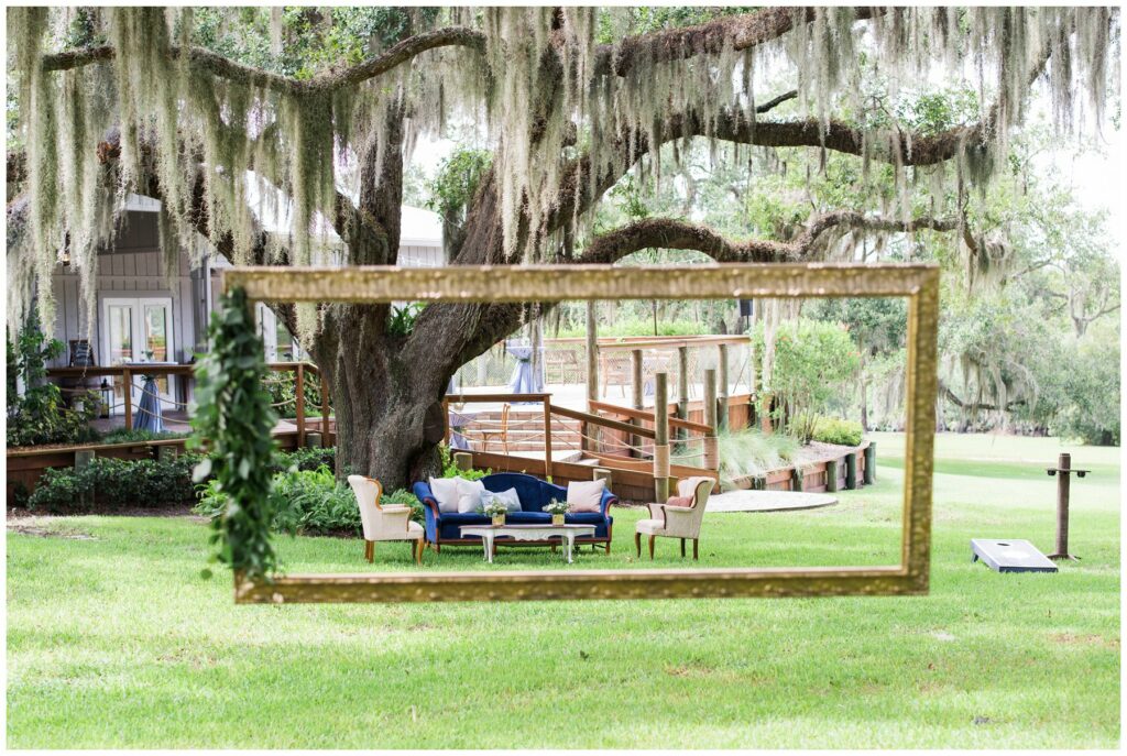 antique gold hanging frame outdoor ceremony decor with classic greenery and vintage velvet lounge set furniture