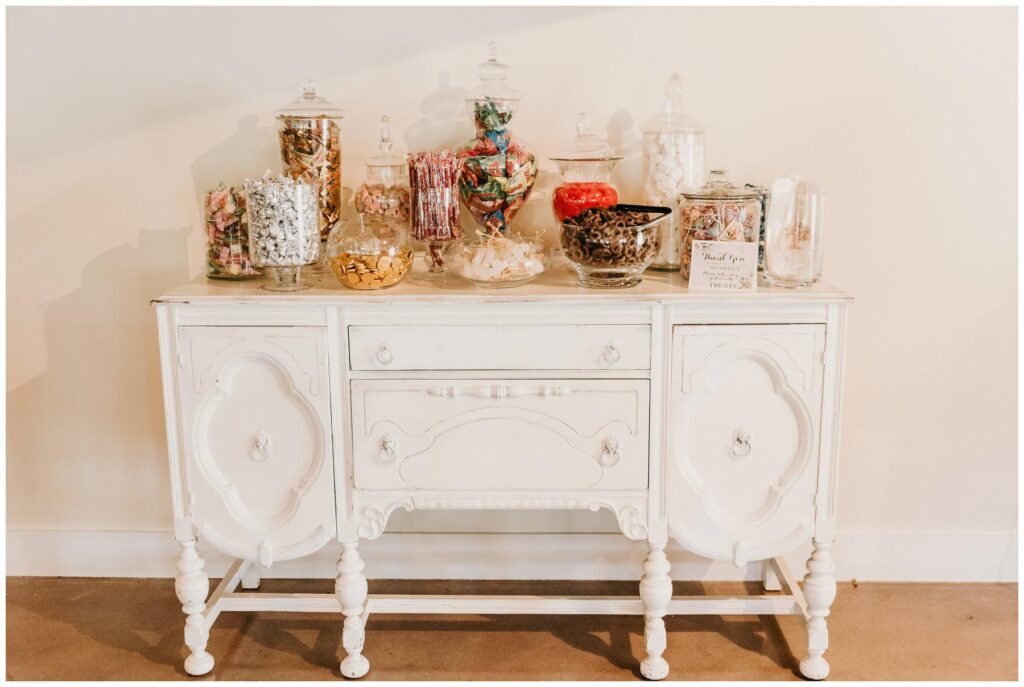 crystal and crates white distressed ava buffet with wedding reception candy display in glass apothecary jars
