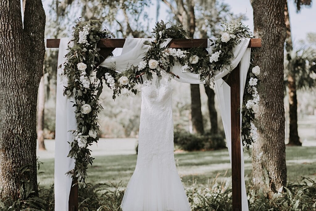 rustic wedding arbor with white florals and greenery 