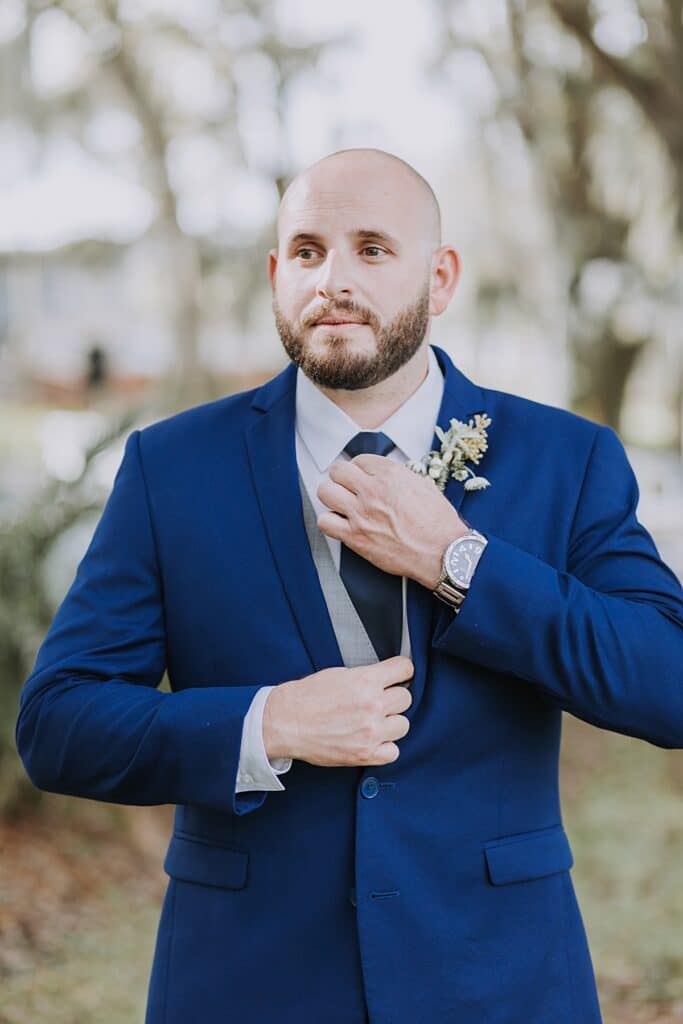 Royal blue groom's suit with organic succulent boutonniere