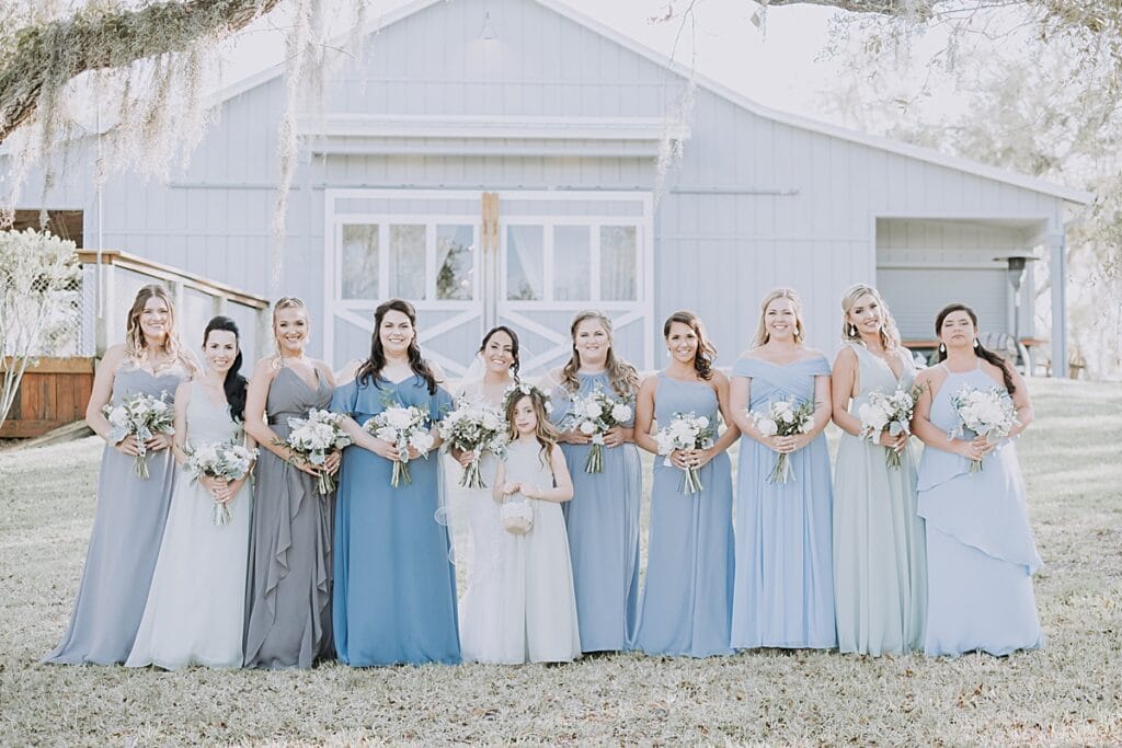 Bridesmaids' dresses in soft shades of blue and gray