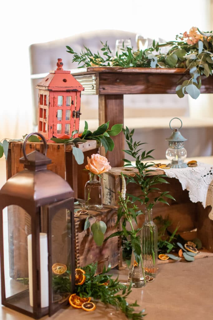 Vintage crates and lanterns with hints of citrus for a rustic southern sweetheart table design.