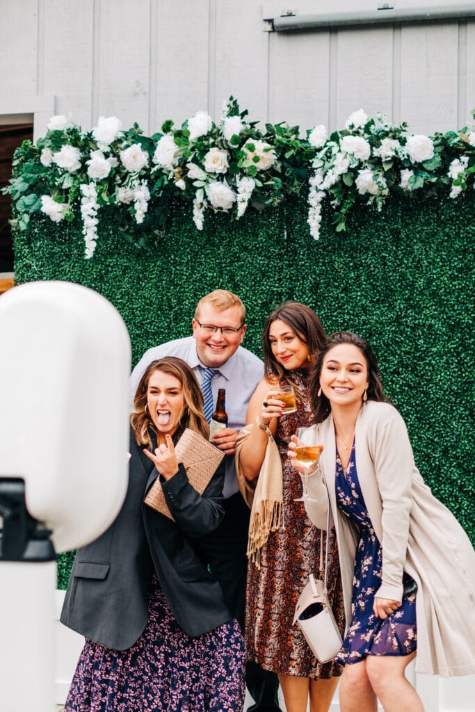 the jewel booth with boxwood greenery wall background