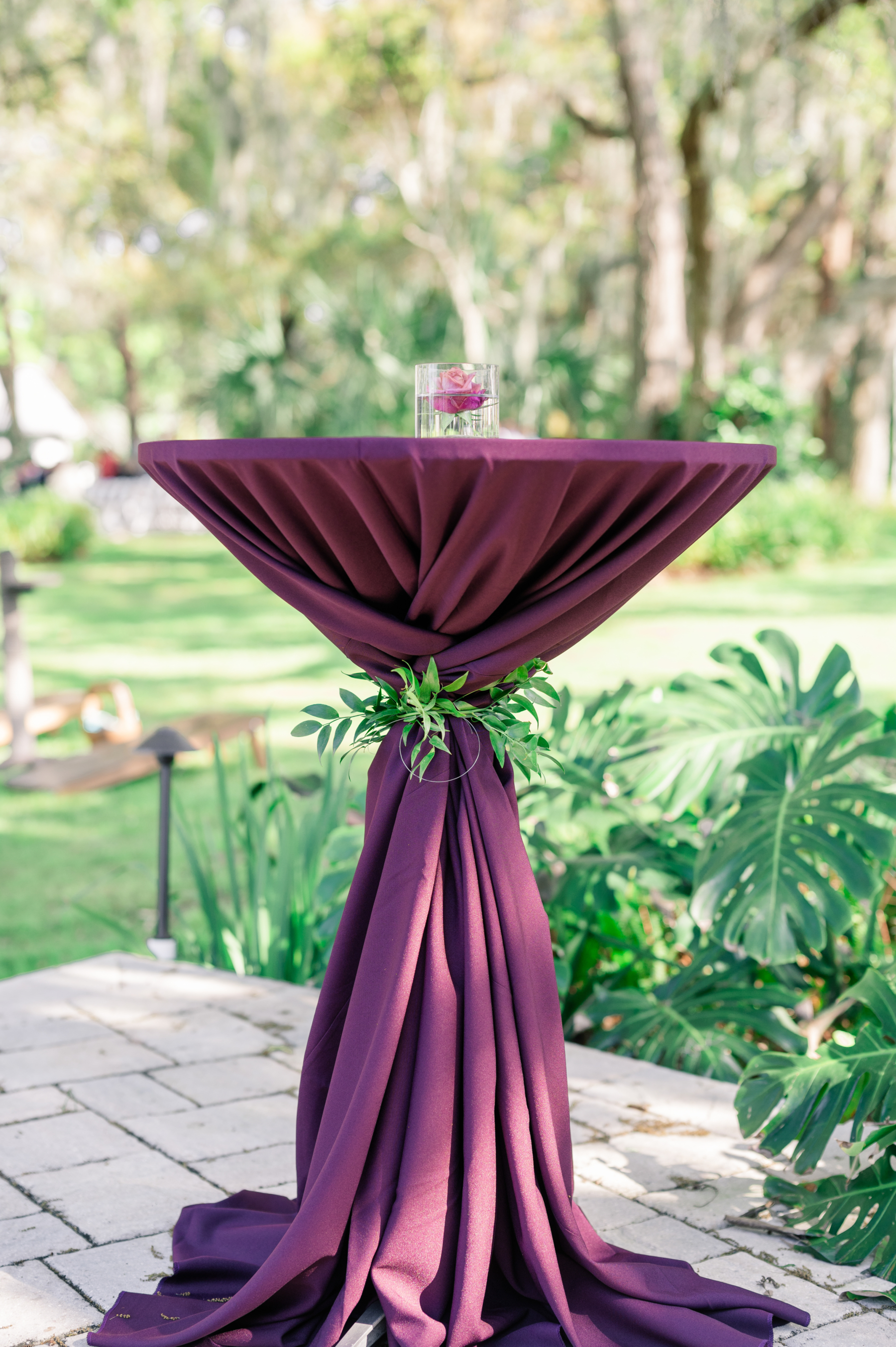 Outdoor cocktail reception with split-leaf philodendron & gem toned accents