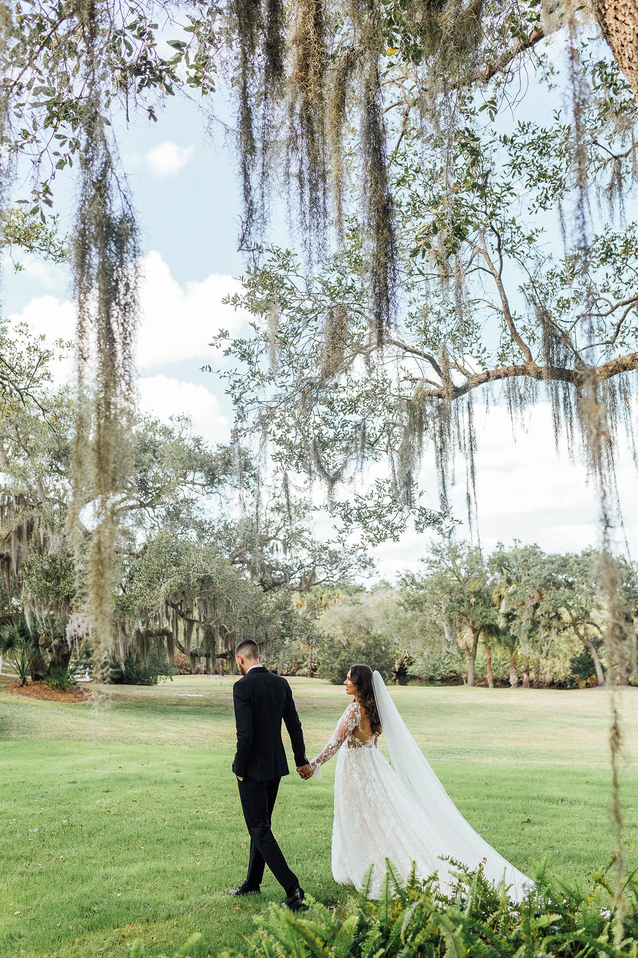 Bride and groom walking across private estate venue