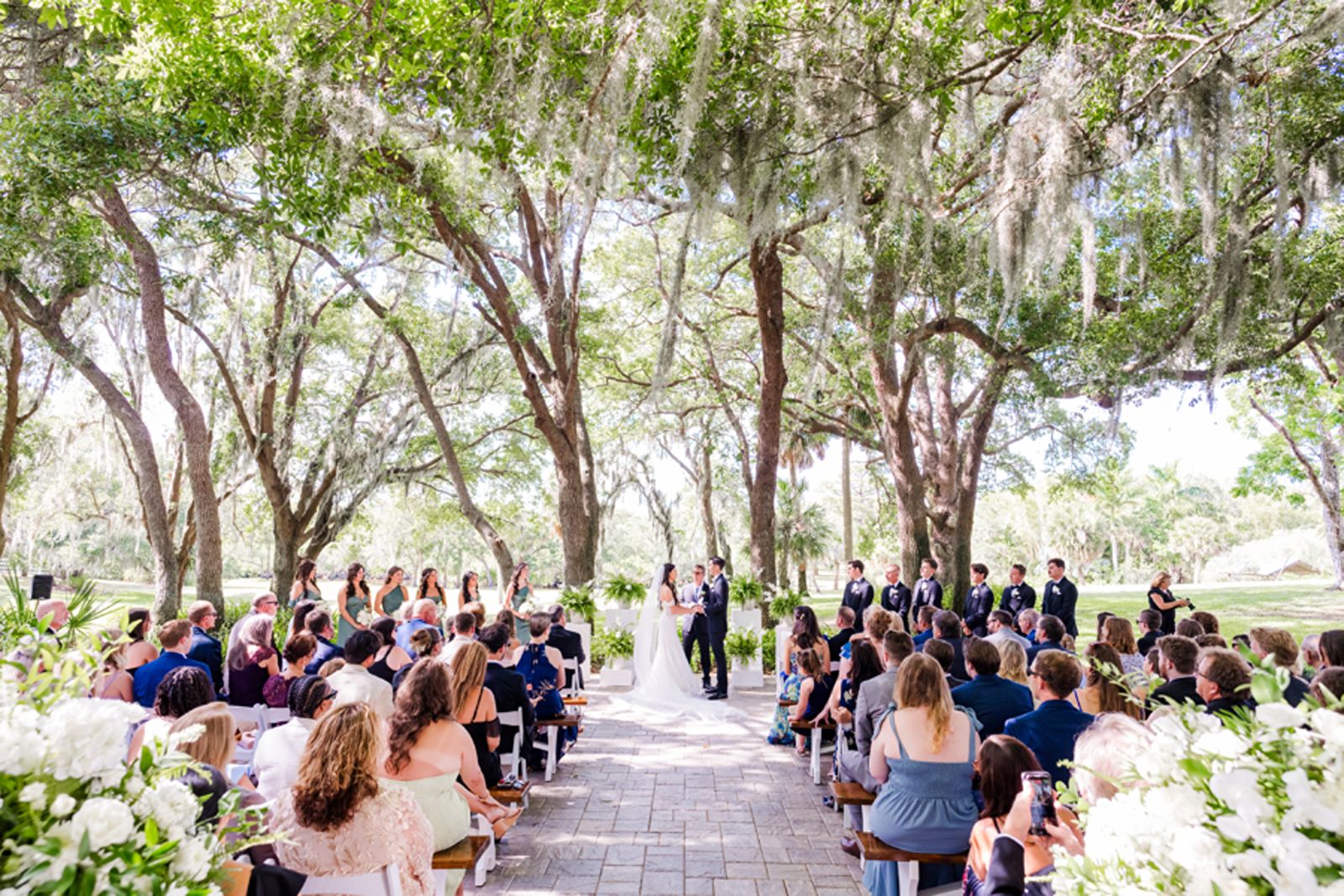 Wedding ceremony at Palm Bay venue draped in oak trees